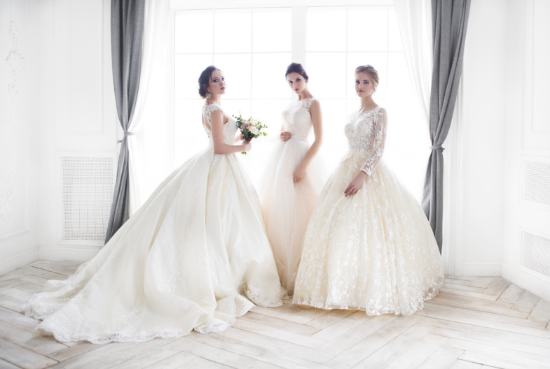 three ladies in wedding dresses